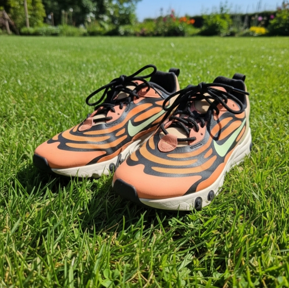 Nike Air Max Torch sneakers featuring a coral orange mesh upper with black wave